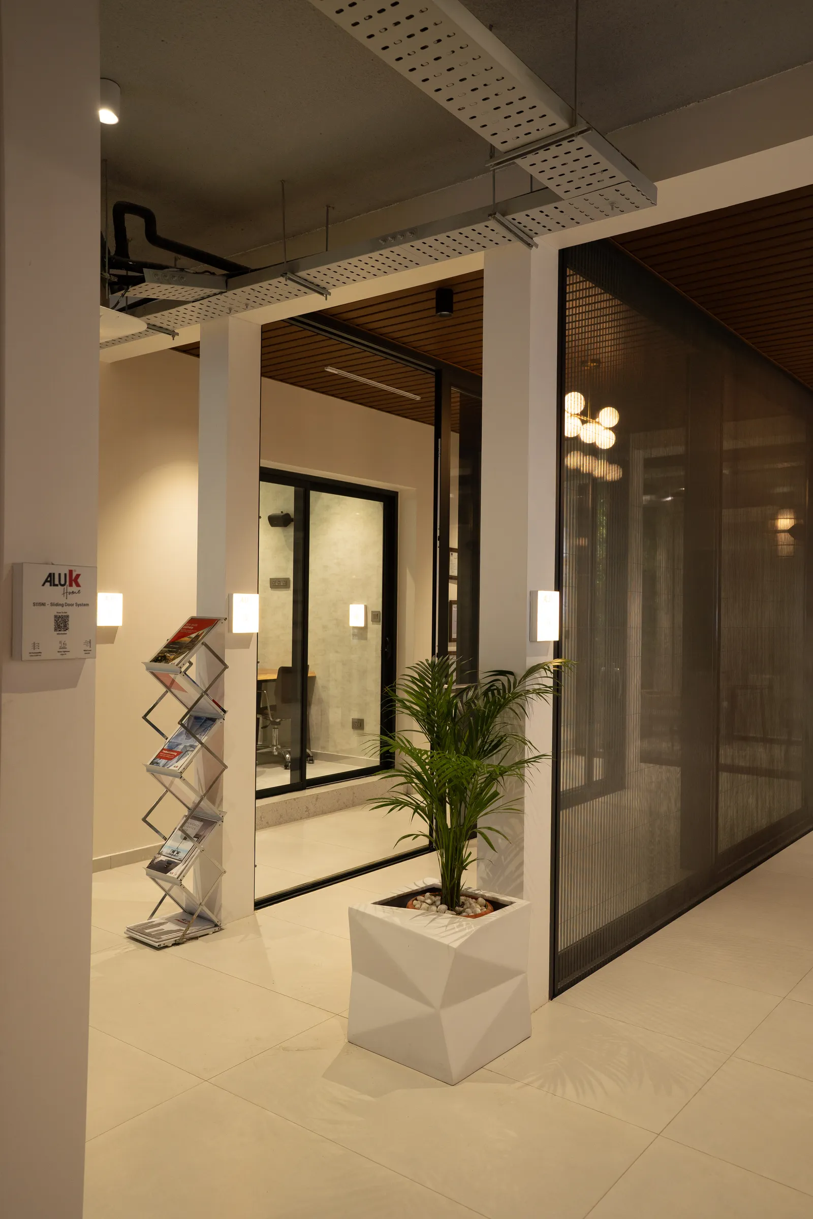Showroom aisle with glass partition systems — Aluk Experience Center